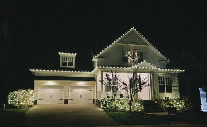 Warm white Christmas roofline lighting on a home in Williamson County, TN