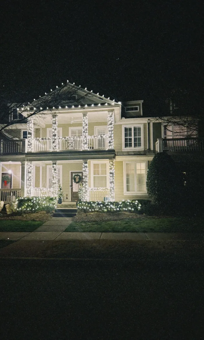 Christmas roofline lighting and a wreath on a home in Williamson County, TN