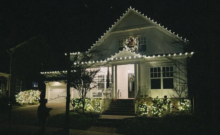 Christmas roofline lighting and a wreath on a home in Williamson County, TN