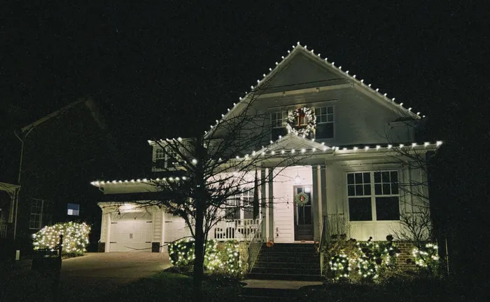 Warm white Christmas roofline lighting on a home in Williamson County, TN