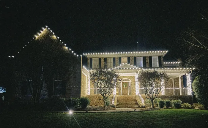 Christmas roofline lighting and a wreath on a home in Williamson County, TN
