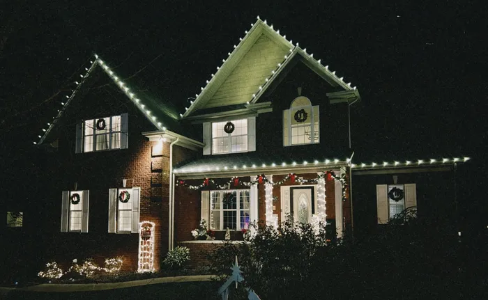 Warm white Christmas roofline lighting on a home in Williamson County, TN