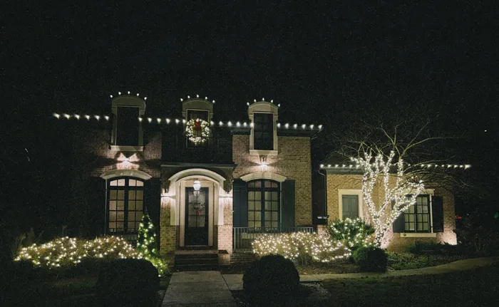 Christmas roofline lighting and a wreath on a home in Williamson County, TN