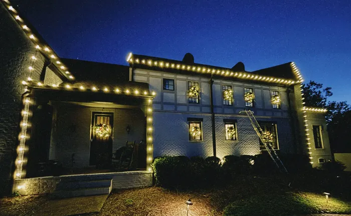 Warm white Christmas roofline lighting on a home in Williamson County, TN